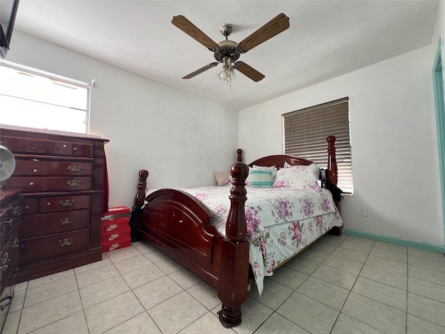 tiled bedroom featuring ceiling fan