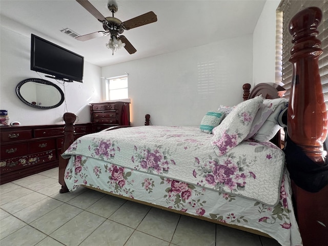 bedroom with ceiling fan and light tile patterned floors