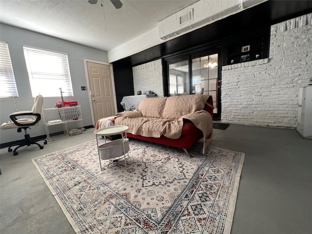 living room featuring ceiling fan, concrete floors, and a textured ceiling