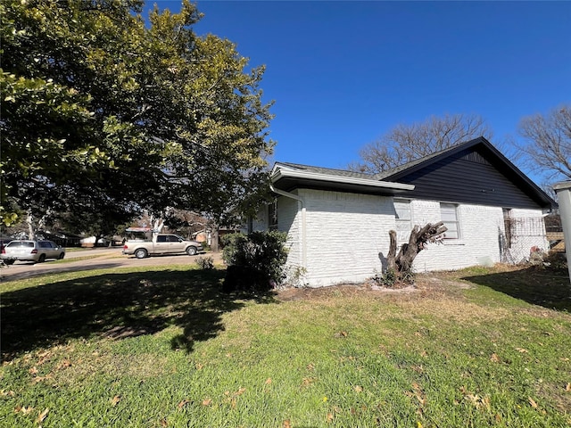 view of side of property with a yard