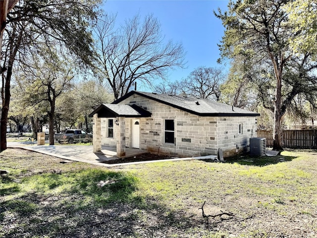 exterior space with central AC unit, a yard, and a patio area