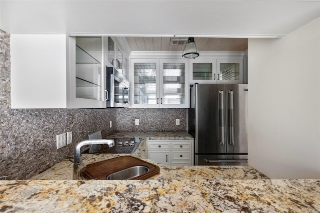 kitchen featuring stainless steel appliances, tasteful backsplash, sink, and white cabinets