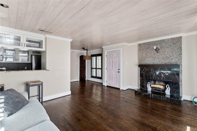 living room featuring crown molding, a premium fireplace, and dark hardwood / wood-style flooring