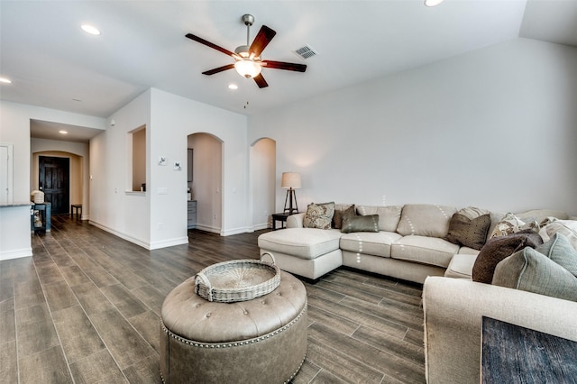 living room with ceiling fan, lofted ceiling, and dark hardwood / wood-style floors