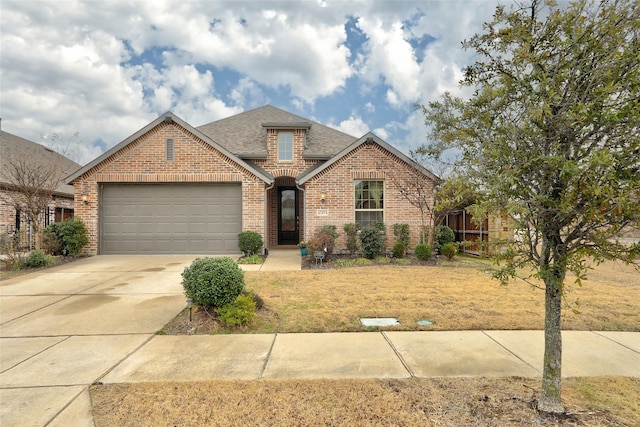 view of front of house featuring a garage and a front lawn