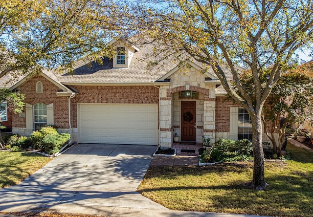 view of front of house featuring a garage and a front lawn