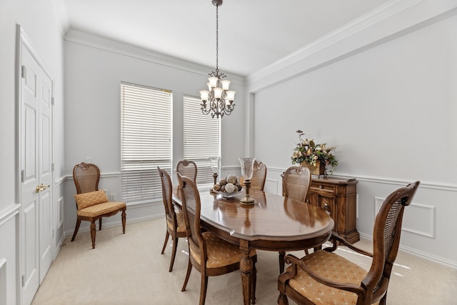 carpeted dining space featuring crown molding and a chandelier