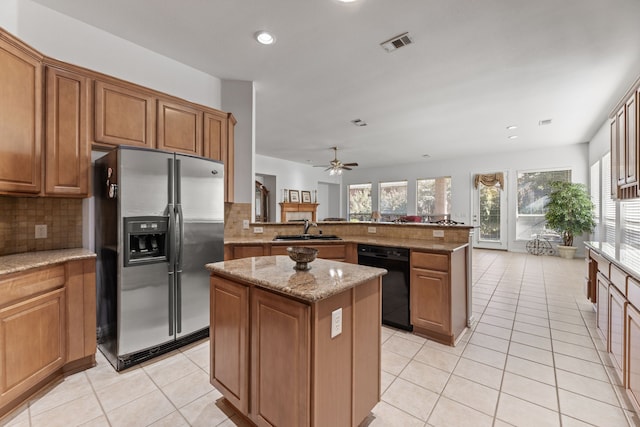 kitchen featuring a kitchen island, black dishwasher, sink, kitchen peninsula, and stainless steel refrigerator with ice dispenser