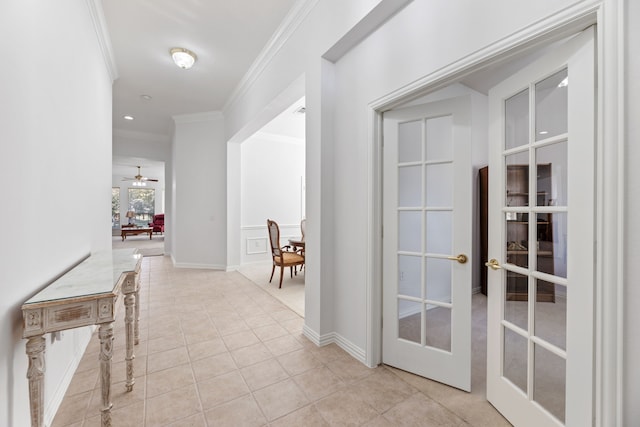 hallway with crown molding, french doors, and light tile patterned flooring