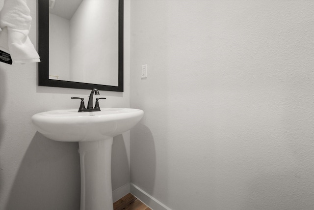 bathroom featuring sink and hardwood / wood-style flooring