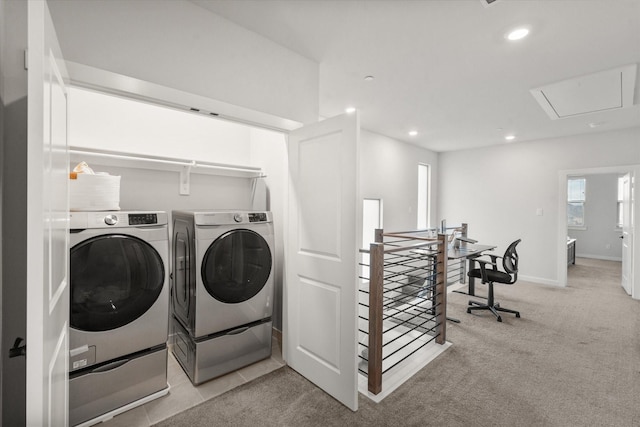 clothes washing area featuring washer and clothes dryer and light carpet