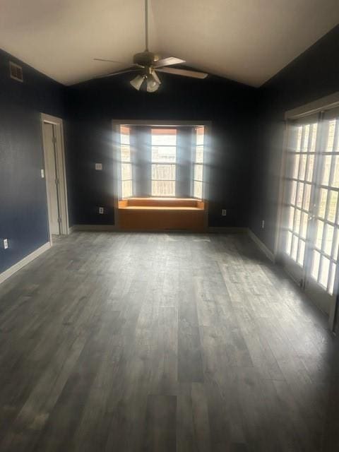 unfurnished room featuring ceiling fan, vaulted ceiling, and wood-type flooring