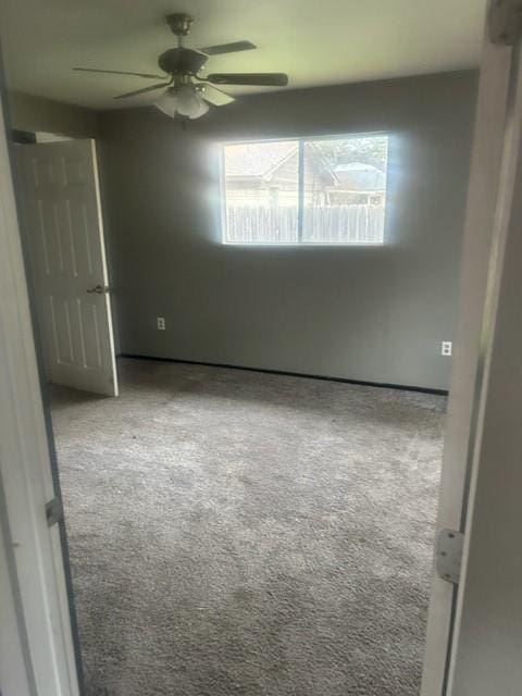 empty room featuring light carpet and ceiling fan