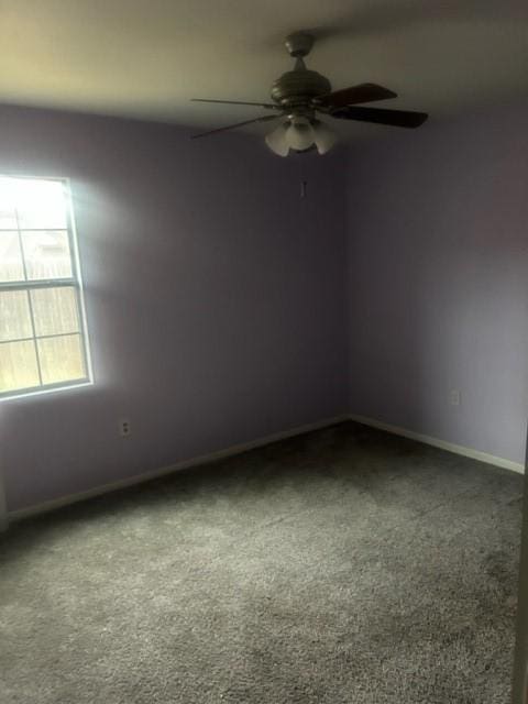 carpeted spare room with ceiling fan