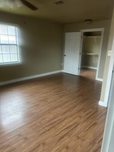 empty room with hardwood / wood-style flooring and ceiling fan