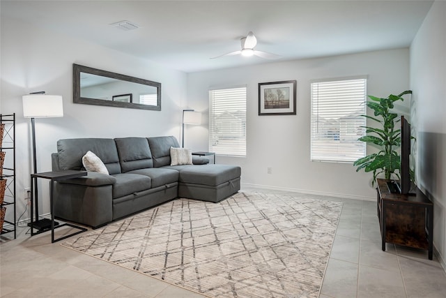 tiled living room with ceiling fan