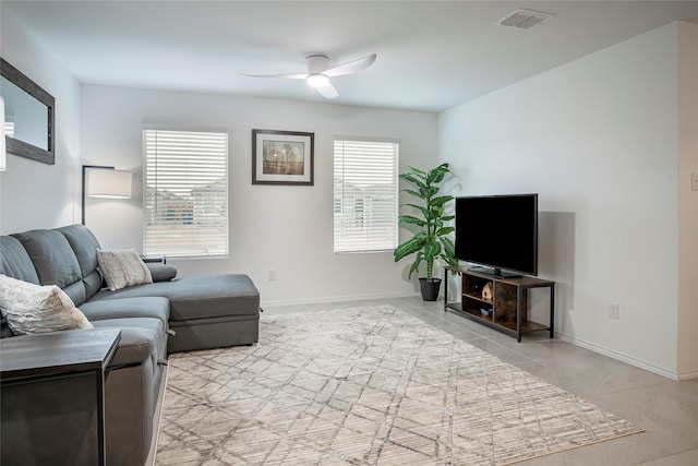 tiled living room featuring ceiling fan