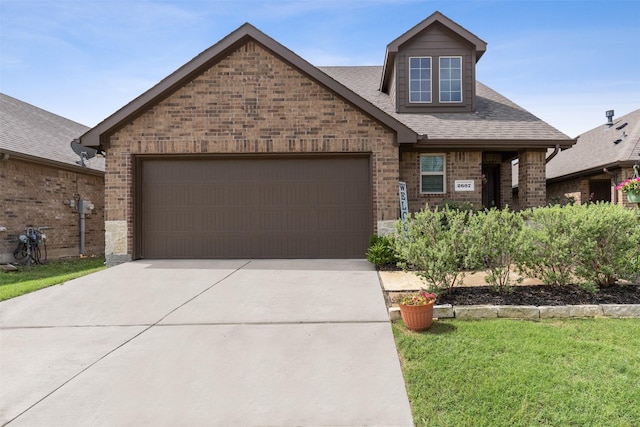 view of front of house with a garage and a front lawn