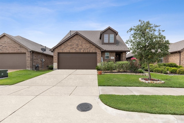 view of front of house featuring a garage and a front lawn