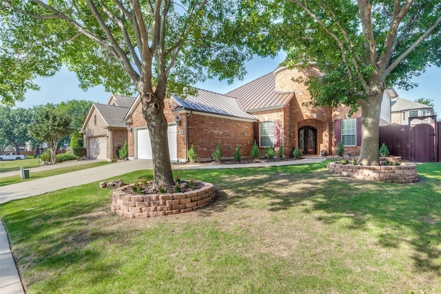 view of front of home featuring a garage and a front lawn