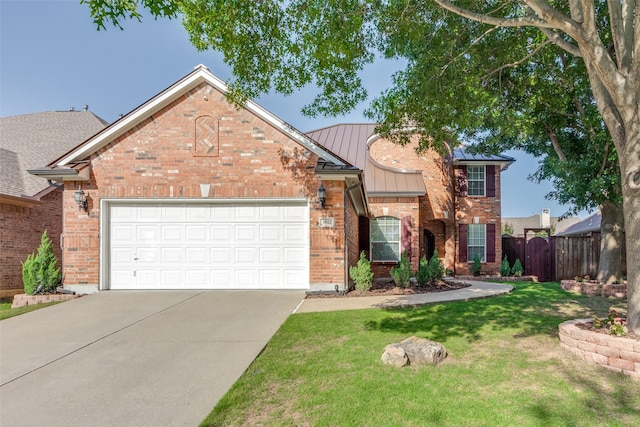 view of front of home featuring a garage and a front yard