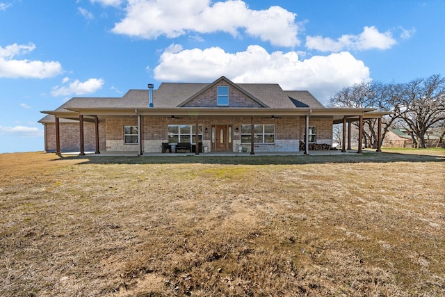 rear view of property featuring a yard and a patio