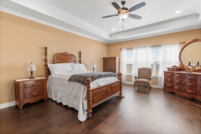 bedroom with crown molding, ceiling fan, dark hardwood / wood-style flooring, and a tray ceiling