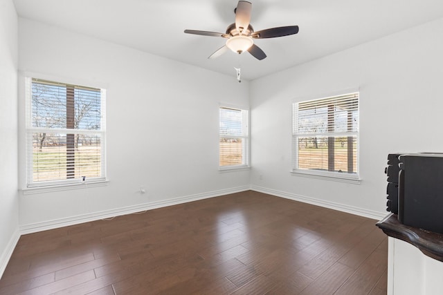 interior space featuring dark wood-type flooring and ceiling fan