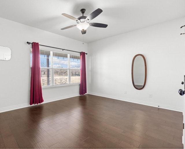 spare room with dark hardwood / wood-style floors, a wall unit AC, and ceiling fan