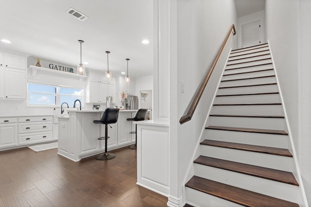 staircase with wood-type flooring