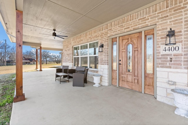 doorway to property featuring a porch and ceiling fan