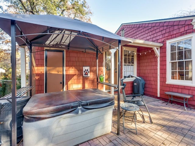 view of patio featuring a hot tub and a gazebo