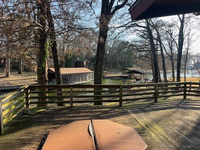 wooden terrace featuring a water view