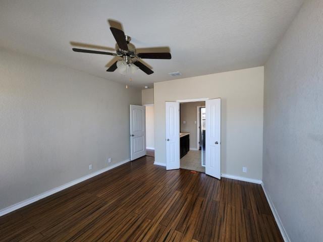 unfurnished bedroom with dark hardwood / wood-style floors and ceiling fan