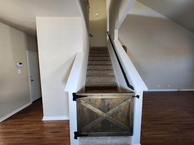 stairway with hardwood / wood-style flooring