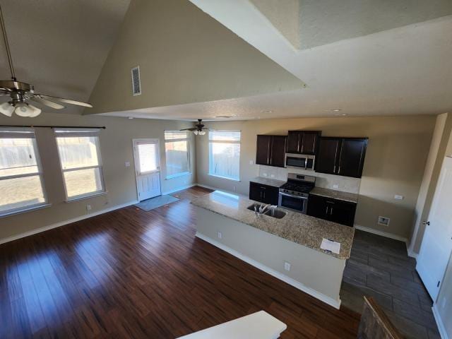 kitchen featuring appliances with stainless steel finishes, dark hardwood / wood-style floors, high vaulted ceiling, ceiling fan, and dark brown cabinetry