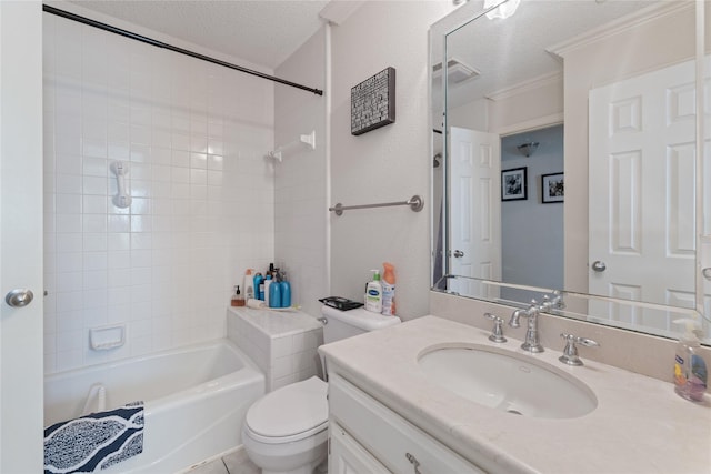 full bathroom featuring vanity, tiled shower / bath, a textured ceiling, and toilet