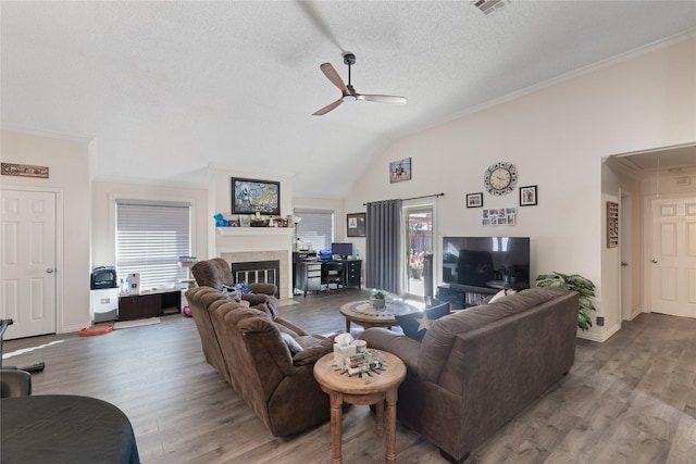 living room with hardwood / wood-style flooring, plenty of natural light, and ornamental molding