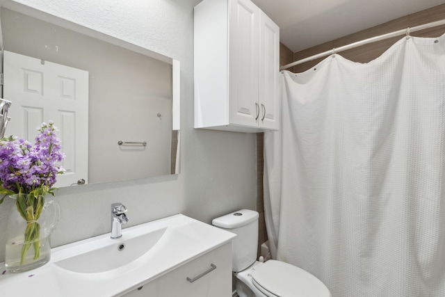 bathroom with vanity, toilet, and a shower with shower curtain