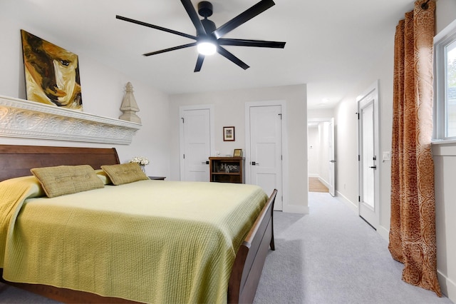 bedroom with ceiling fan and light carpet