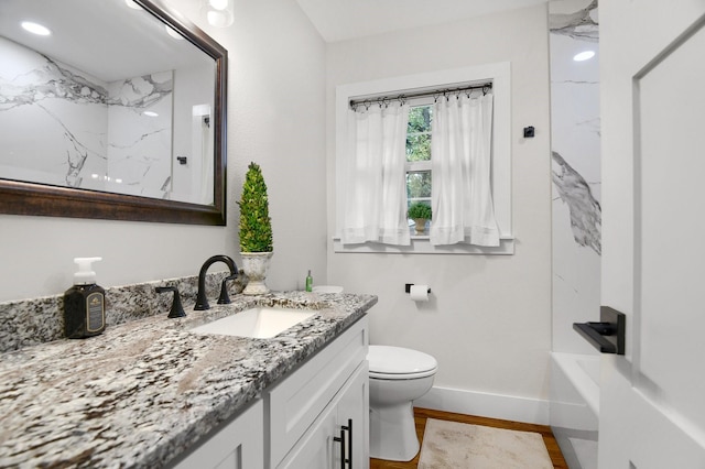 full bathroom featuring vanity, wood-type flooring, bathtub / shower combination, and toilet