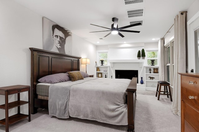 bedroom featuring light colored carpet and ceiling fan