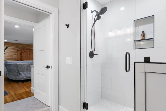 bathroom featuring a shower with shower door