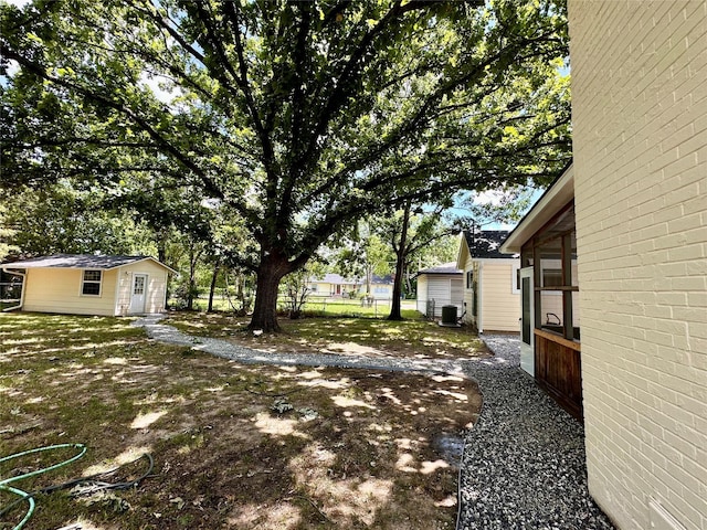 view of yard featuring an outbuilding and cooling unit