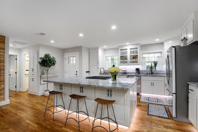 kitchen featuring white cabinetry, a kitchen island, and appliances with stainless steel finishes