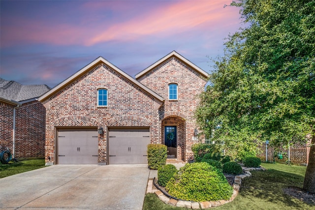 french country inspired facade featuring a front yard, brick siding, driveway, and an attached garage