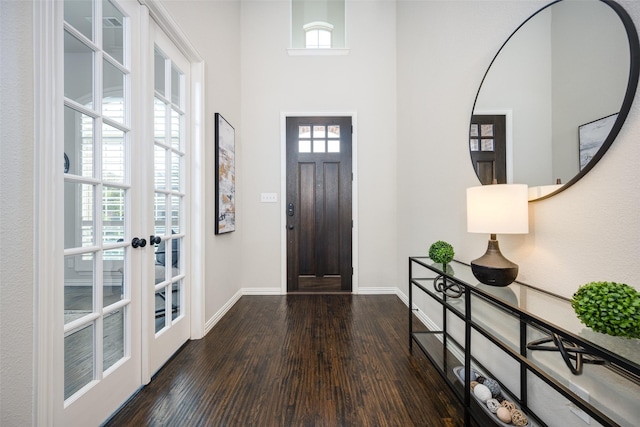 foyer entrance with baseboards, dark wood-type flooring, and french doors