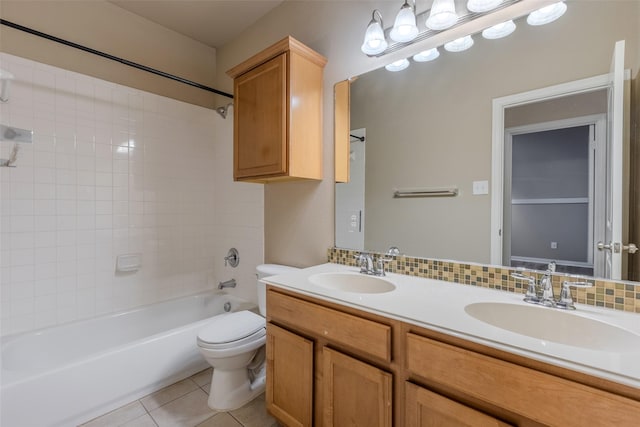 full bathroom with tiled shower / bath, decorative backsplash, tile patterned flooring, vanity, and toilet