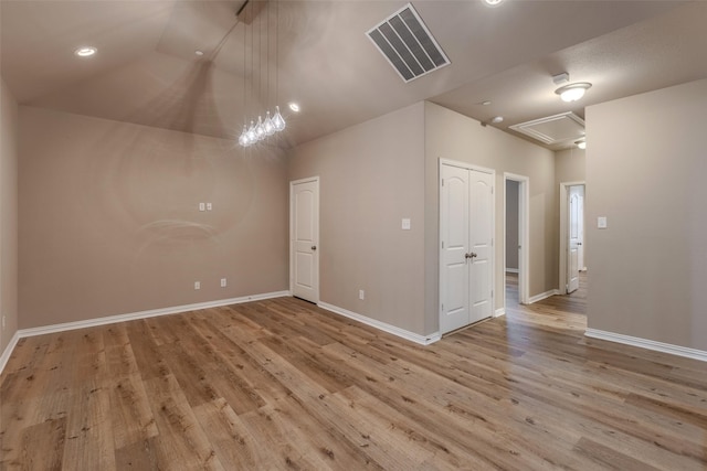 unfurnished room with vaulted ceiling and light hardwood / wood-style flooring