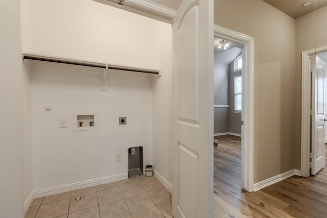 laundry area with hookup for a gas dryer, hookup for an electric dryer, washer hookup, and light hardwood / wood-style floors